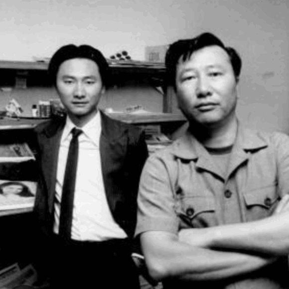 Black and white photo of two people looking at the camera