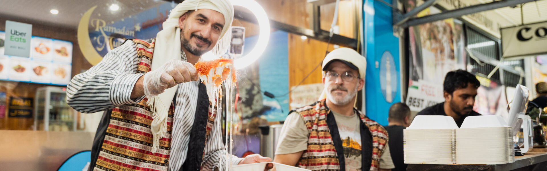 two men cooking in the street - happy scene