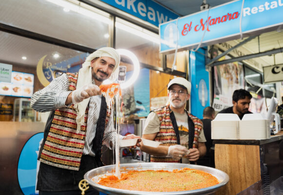 two men cooking in the street - happy scene