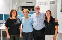 Four people looking at the camera