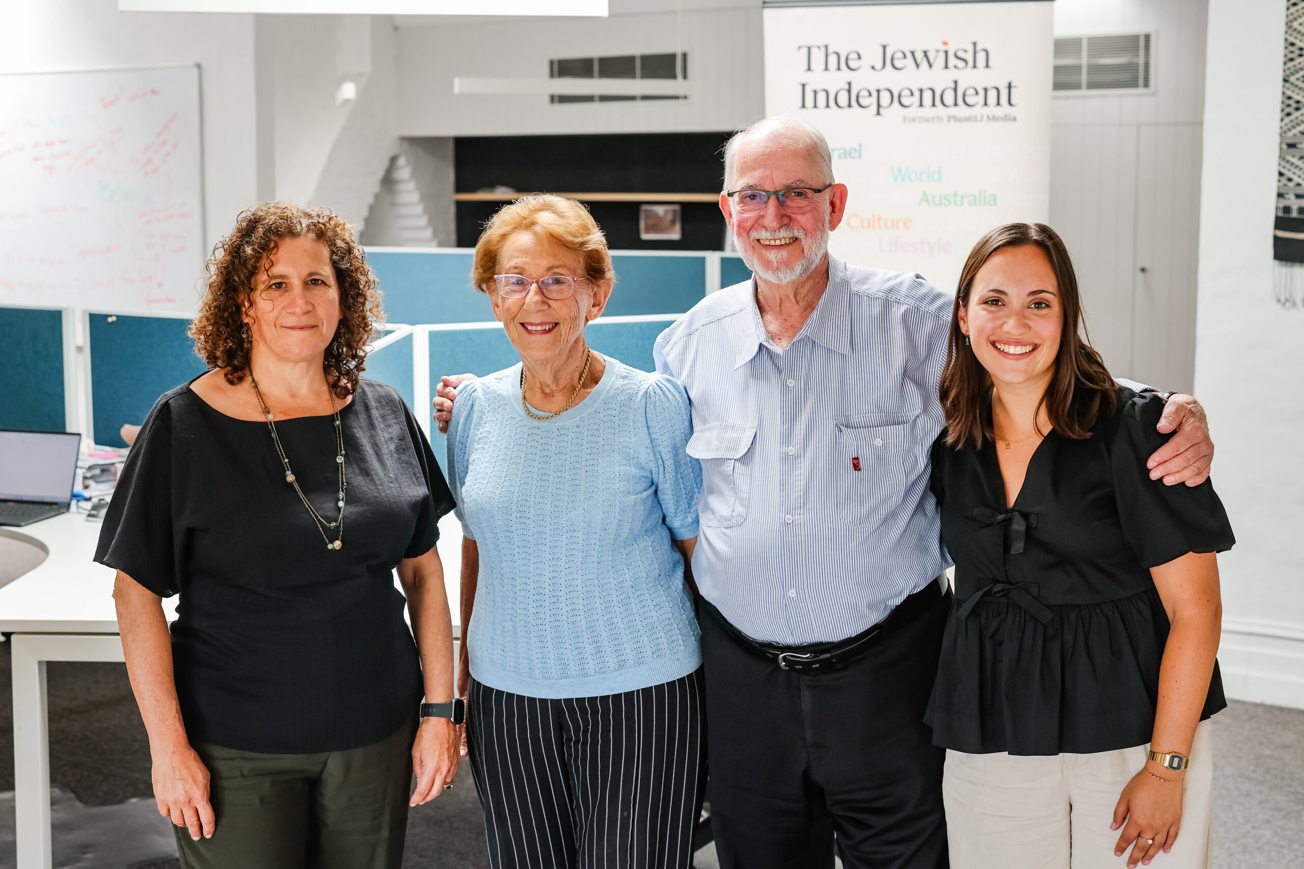 Four people looking at the camera