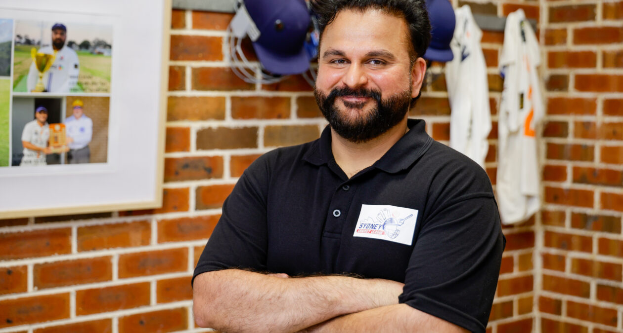 man in a sport shed smiling at camera