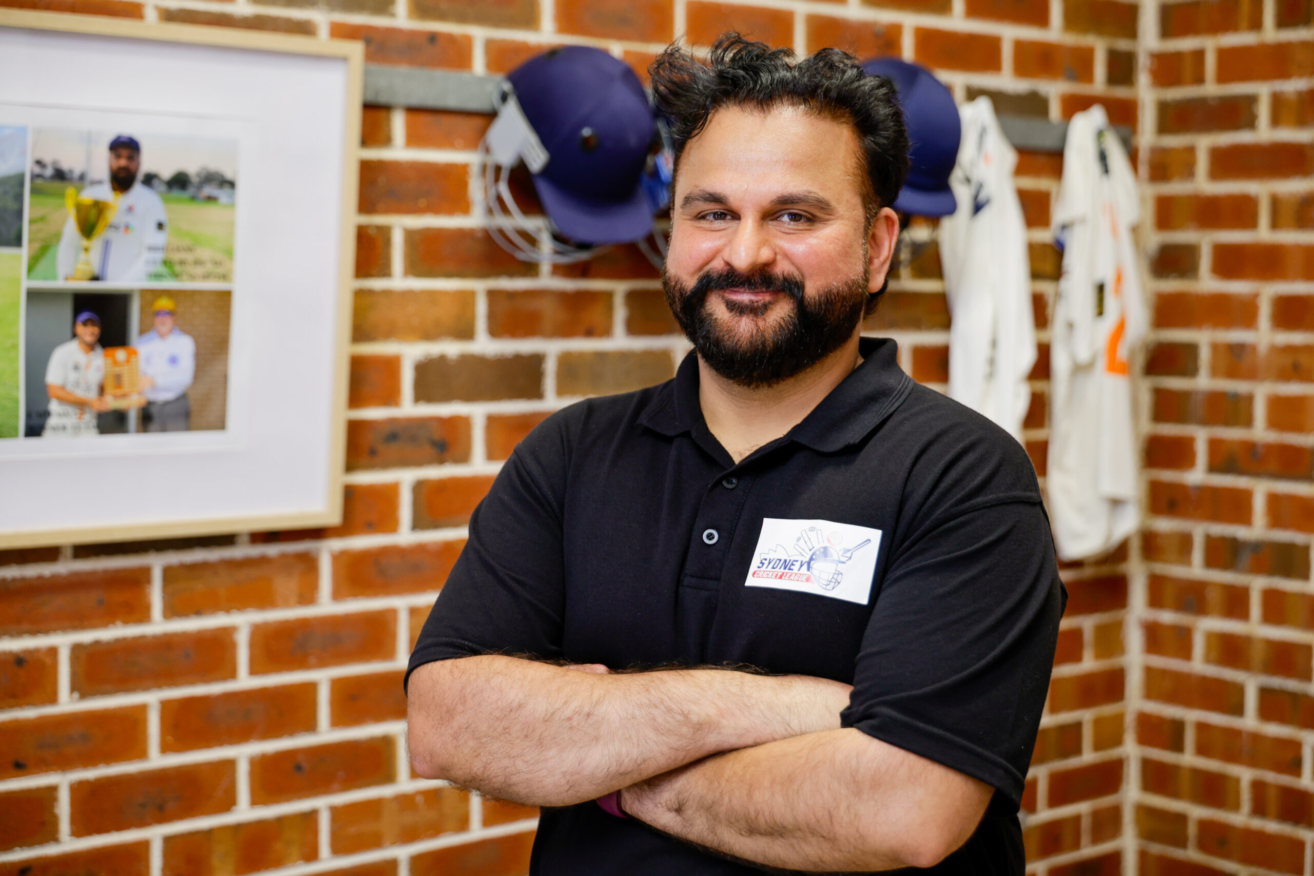 man in a sport shed smiling at camera