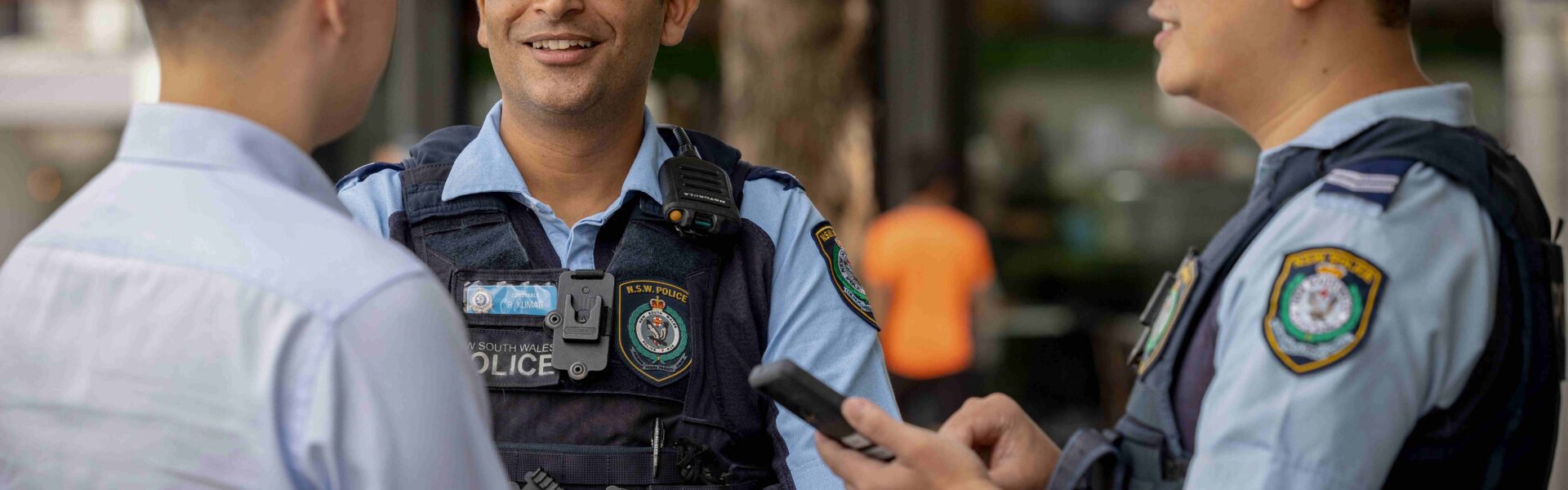 two police force officers speaking with another person