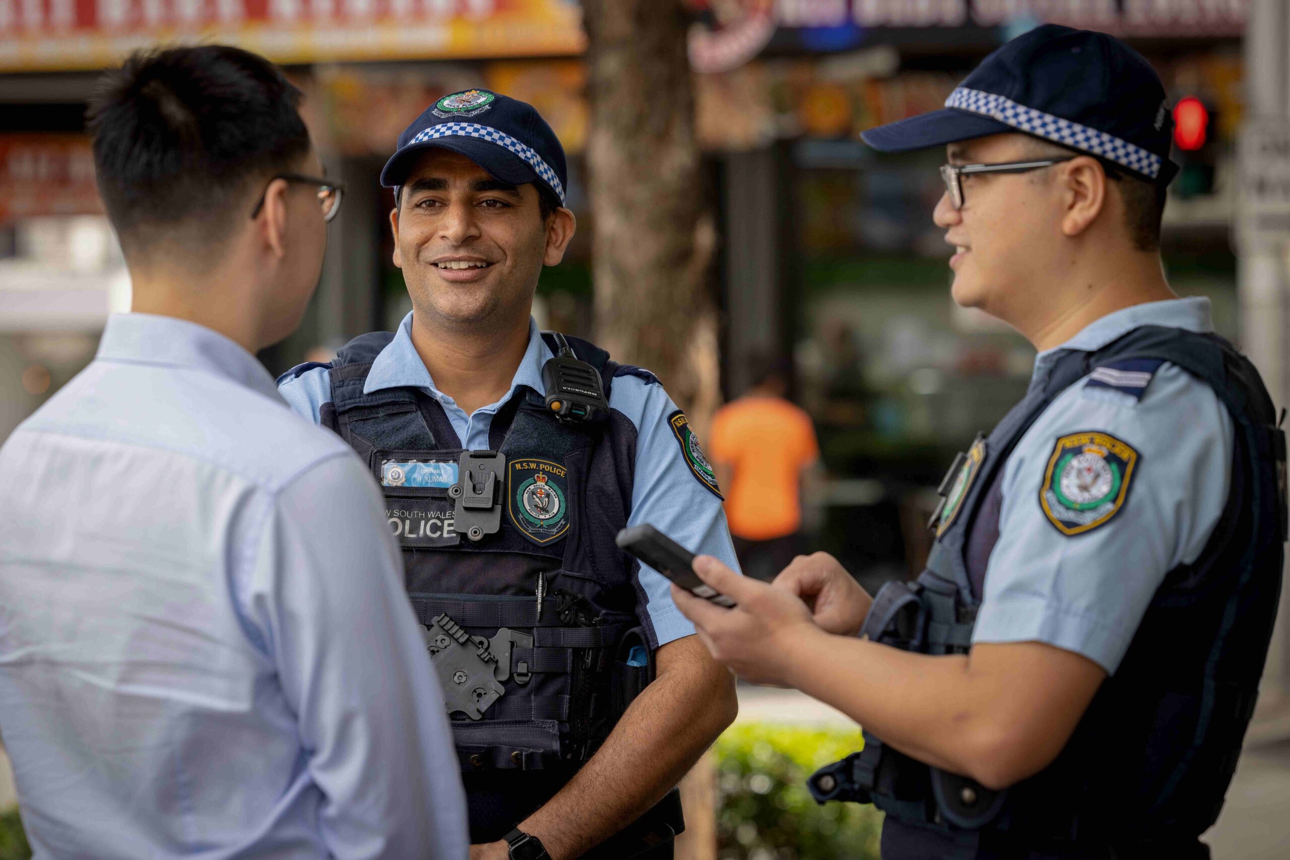 two police force officers speaking with another person