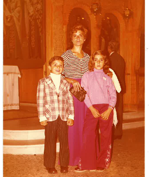 Faded photo of an adult and a boy and a girl in 70s style dress